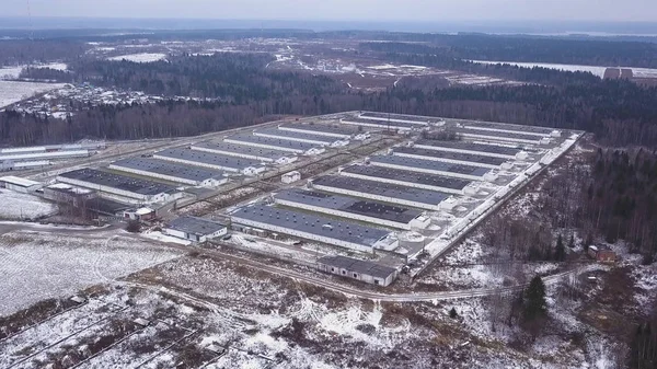 A modern factory or commercial building, the exterior of a modern factory or plant, building facade . Construction of a modern factory or plant, Industrial area in winter, panoramic view from the air