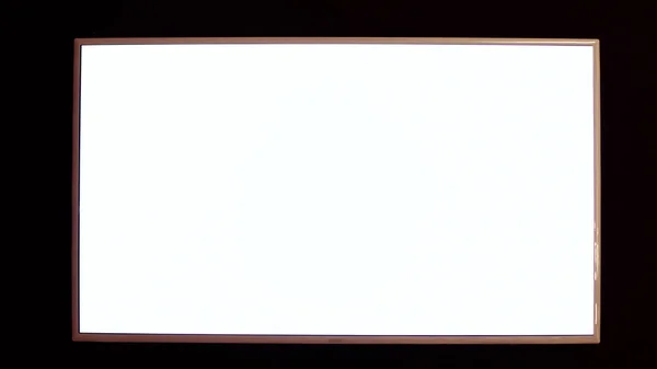 Modern blank flat screen tv set, isolated on a black background. Isolated black flat wide tv. LED television screen mockup, blank hdtv isolated on black background — Stock Photo, Image