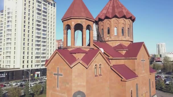 Templu creștin din cărămizi roșii cu fundal de oraș. Biserica Ortodoxă Rusă din oraș, cărămidă roșie pe cerul albastru — Videoclip de stoc