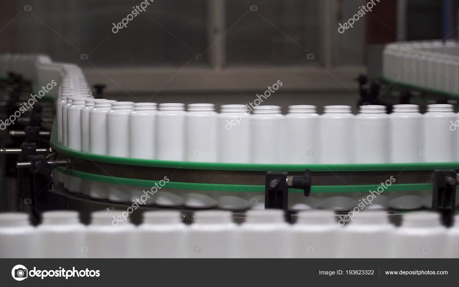 Packed bottle moving on conveyor belt. Clip. Plastic bottle on the