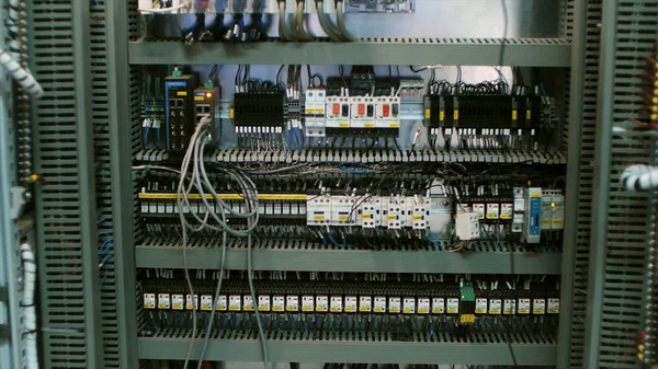 Wires in a box of distribution of an electricity. Clip. Electrical panel with fuses and contactors. Several contactors arranged in a row in an electrical closet — Stock Photo, Image
