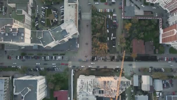 Construction in the city with a crane manipulator. Video. Top view of the construction site in the city — Stock Video