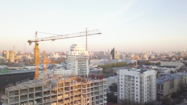 Construction site with cranes. Video. Construction workers are building. Aerial view. Top view of the construction site in the city. Construction in the city with a crane manipulator — Stock Video