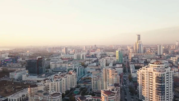 Sunset in megapolis. Video. Beautiful cityscape with top view on skyscrapers. Top view of the modern city at sunset