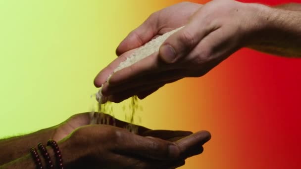 Support concept. Stock. Empathy, compassion, help, kindness. Humanitarian assistance to African countries. Hands pour rice into the hands of a black man — Stock Video