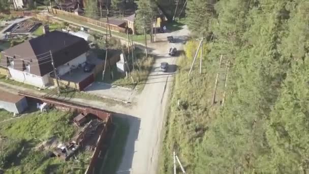 Vista aérea. Vídeo. Vista aérea de los coches que conducen en una carretera en el pueblo. Rusia. Verano — Vídeos de Stock