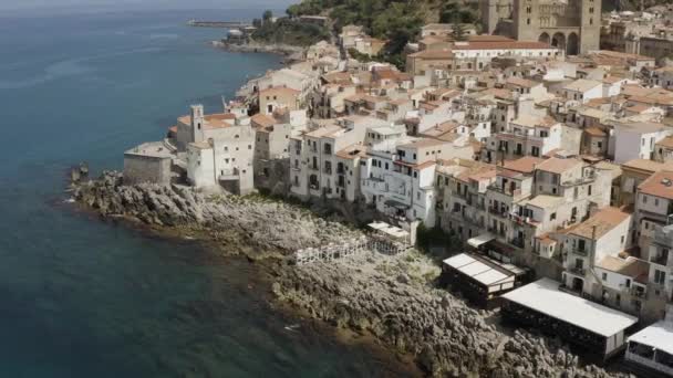 Aerial view of the stony coast, azure sea, and the European city in Italy. Action. Travel and holyday concept, beautiful houses near the sea. — Stock Video