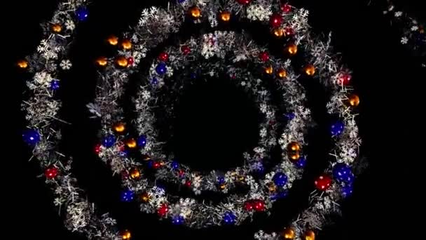 Christmas or New Year wreath spiral spinning on black background, seamless loop. Animation. Abstract blue garland of snow flakes and Christmas tree decorations. — Stock Video