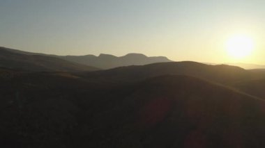 Güneşli dağ ormanlarının en üst manzarası. Vuruldu. Tepedeki tepelik alanın güneş ışığı manzarası