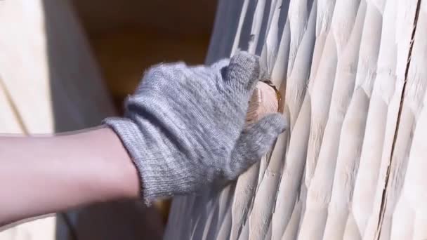 Close up of a carpenter hand clogging of dowel at the construction site. Clip. Process of building wooden house by a professional worker. — Stock Video