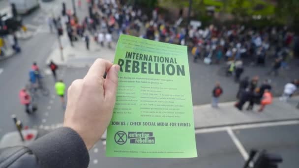 London, UK - October 2019: International rebellion leaflet in London. Action. Climate change eco protesters at the Extinction Rebellion demonstration at St. Jamess Park Westminster London, in protest — Stock Video