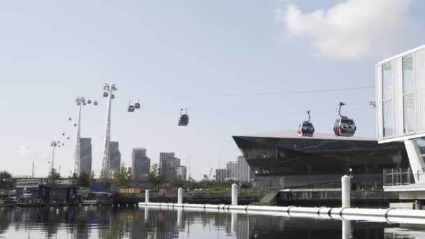 Summer landscape of the cable car above the river on blue cloudy sky background. Action. Beautiful glass facade building and skyscrapers in the city. — Stockvideo