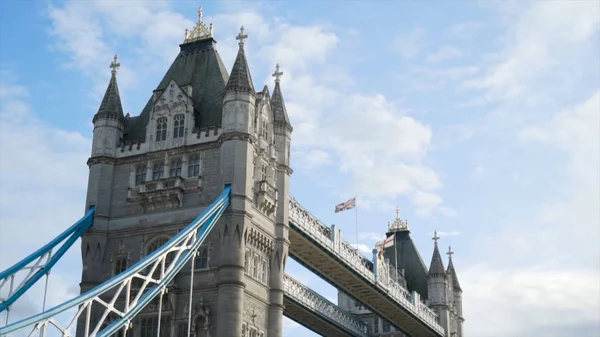 Close-up of ancient architecture of bridge with towers. Action. Beautiful medieval figure of famous bridge towers in UK on blue sky background — Stock Photo, Image