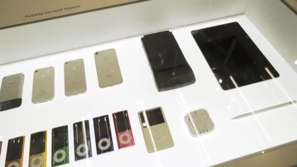 New York, Stati Uniti - 11.20.2019: Mostra all'interno di Apple Museum, collezione di prodotti Apple. Azione. Vecchi modelli di Iphone, Ipodi, Ipad, orologi Apple, air pods e stilo . — Video Stock