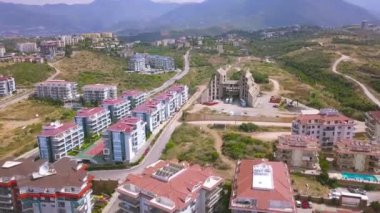 Tepe manzaralı bir yer ve şehrin evleri. - Sanat. Güney kasabasının çatıları yeşil çalılar, ağaçlar, doğa ve ekolojik yaşam yerleriyle çevrili..
