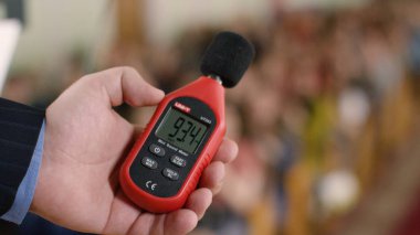 Decibelometer close-up. Stock footage. Measurement of sound volume in the audience. Experiment. Sound level meter clipart