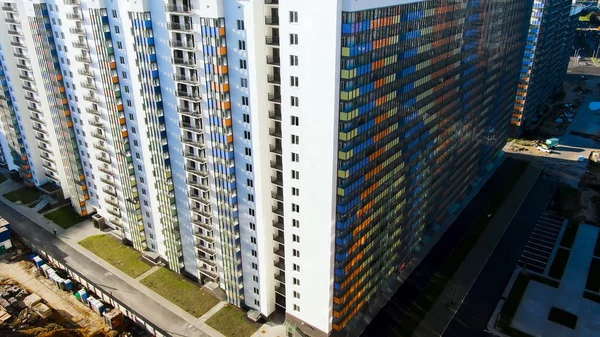 Aerial view of residential skyscrapers in the new expanding city district. Motion. Housing development and infrastructure concept in modern American city.