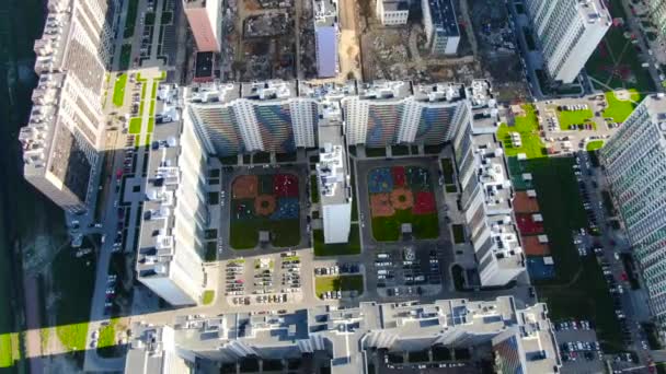 Residential high-rise buildings with of complexes under construction. Motion. Top view of visible contrast of nearby built and populated area — Stock Video