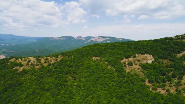 Blick von oben auf schöne grüne Bergrücken vor blauem Himmel. Schuss. schöne Berglandschaft mit sattgrünem Gras auf den Gipfeln im schönen Sommer — Stockvideo