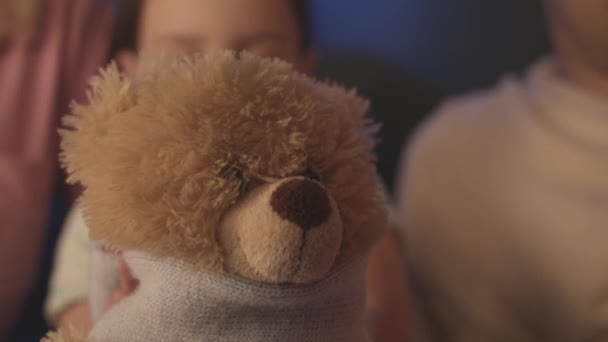 Діти граються з іграшками. Відеоматеріал. Прекрасний Тедді ведмідь маленької дитини. Дівчинка доглядає Тедді ведмедів і зв'язує його шарфом. — стокове відео