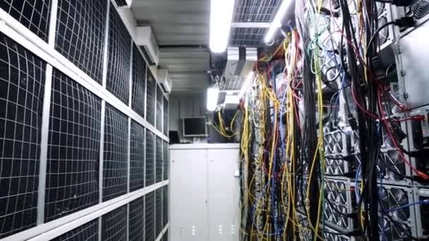 Inside room with data centers and cables. Stock footage. Room with data centers, cables and solar panels to absorb bright artificial lighting — 비디오
