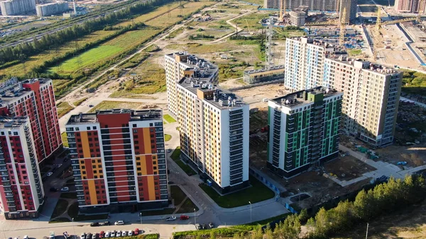 Top view of building area of residential buildings. Motion. Beautiful area with new colored high-rise buildings for residential area of modern city in summer