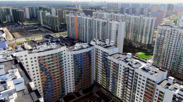 Top view of building area of residential buildings. Motion. Beautiful area with new colored high-rise buildings for residential area of modern city in summer