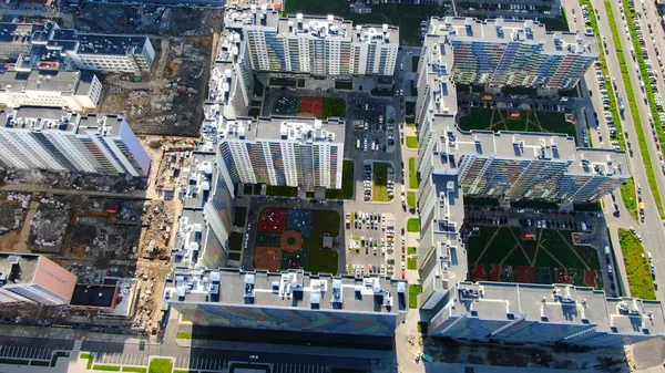 Residential high-rise buildings with of complexes under construction. Motion. Top view of visible contrast of nearby built and populated area