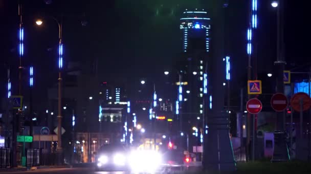 Modern urban city with traffic at night. Stock footage. Colorful light of the city center and the road with driving cars, night life concept. — 비디오