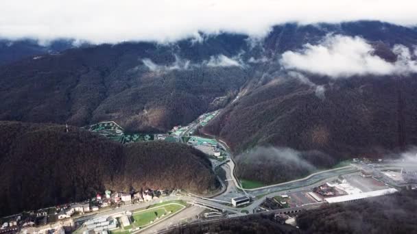 Large hotel complex and mountain resort in late autumn. Stock footage. Breathtaking hill slopes covered by trees under the heavy clouds. — Stock Video