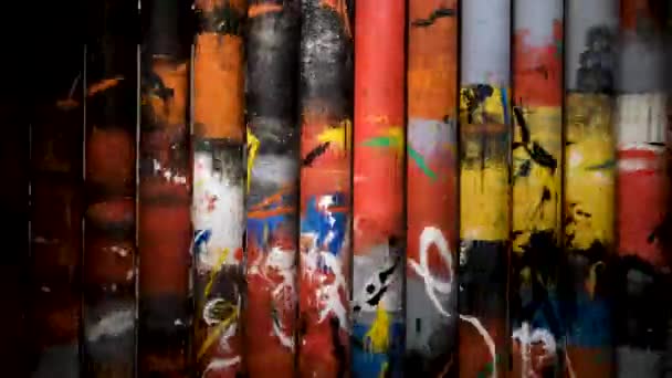 Close up of interesting composition with rotating tubes with bright paintings. Concept. Spinning columns, art object inside the modern art museum. — Stock Video