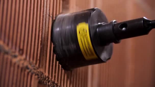 Close up of boring hole process in wall for electric outlet by power hammer drills tool. Stock footage. Making a hole inside red brick wall with a professional equipment. — 비디오