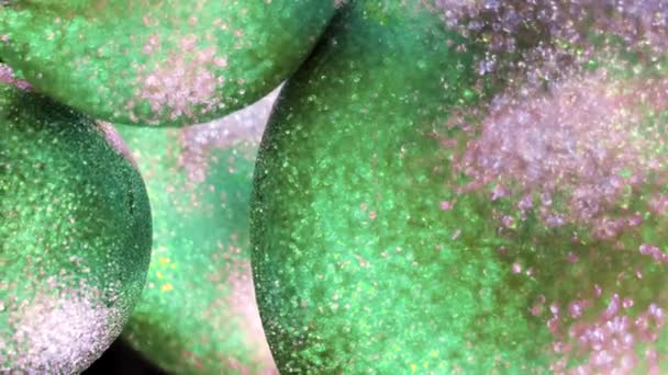 Close up of blurred colorful balls of green and silver colors. Concept. Beautiful Christmas or New Year decoration swaying slightly. — Stock Video