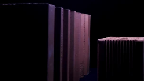 Close up of set of bricks standing isolated on black background. Stock footage. Two large ceramic blocks under the moving light of the flashlight. — Stock Video
