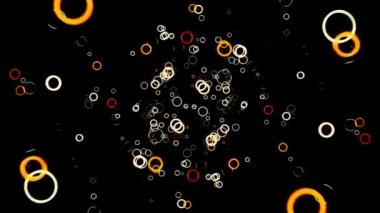 Birçok küçük renkli çember koyu bir arka planda belirir ve yavaş hareket eder, pürüzsüz bir döngü. Animasyon. Güzel sarı ve turuncu halkalar 3 boyutlu hareketlerle düşüyor..