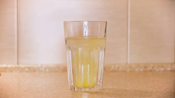 Brausetablette, die in ein Glas mit Wasser, Krankheiten und Medikamenten gegeben wird. Konzept. Nahaufnahme der Hand, die Medikament ins Wasser wirft. — Stockfoto