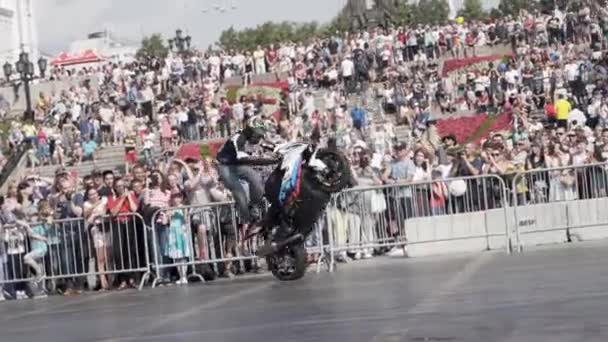 Ekaterimburgo, Rusia-agosto de 2019: Motociclista realiza acrobacias en el espectáculo de estilo libre. Acción. Emocionante truco de motociclista profesional en el equilibrio de la motocicleta en el fondo de la multitud — Vídeos de Stock