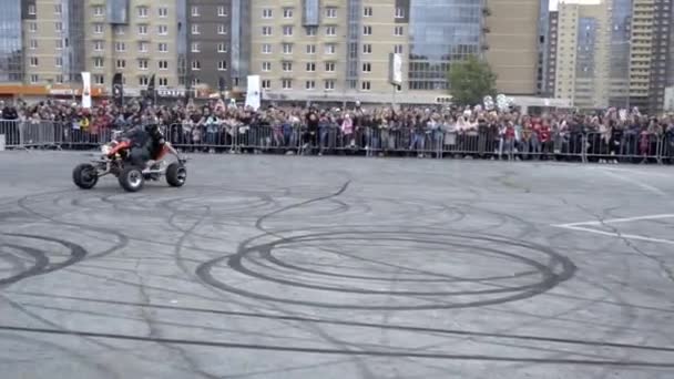 Yekaterinburg, Rusland-augustus 2019: Man is on Atv voert stunts uit. Actie. Professionele Quad fietser toont trucs op de achtergrond van de menigte van mensen achter het hek — Stockvideo