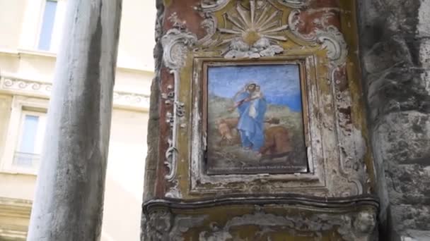 Medieval painting on castle wall. Action. Battered old painting or icon weighs on stone wall of medieval building. Beautiful old painting of Jesus in castle — Stock Video