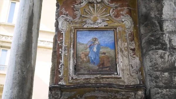 Medieval painting on castle wall. Action. Battered old painting or icon weighs on stone wall of medieval building. Beautiful old painting of Jesus in castle — Stock Photo, Image