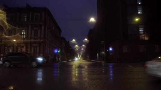 Hermosa ciudad nocturna con tráfico y alumbrado público después de la lluvia. Viaje. Ciudad nocturna con tráfico de coches y alumbrado público reflejado en asfalto húmedo después de la lluvia — Vídeo de stock