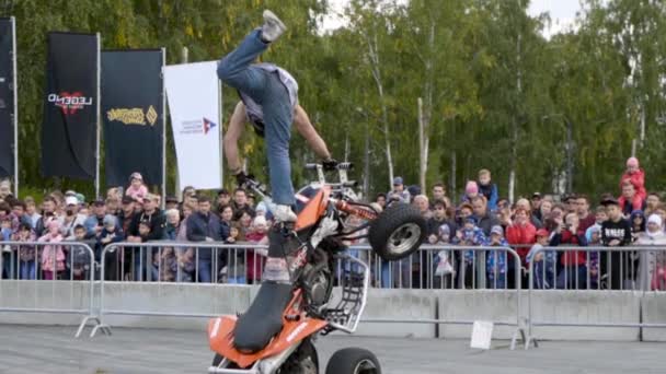 Yekaterinburg, Russia-August, 2019: Man on Quad bike performs tricks. Action. Professional stunt rider on Quad bike performs acrobatic stunts on background of crowd at freestyle show — ストック動画