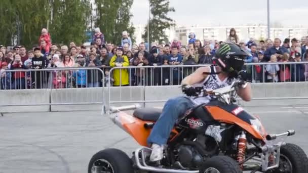 Man op Quad fiets drift. Actie. Professionele drift op Quad bike maakt deel uit van freestyle show. Freestyle show met trucs op Quad fiets in de achtergrond van menigte — Stockvideo