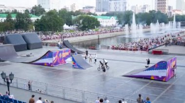 Yekaterinburg, Russia-August, 2019: Festival in city with freestyle show on square. Action. Panoramic view of freestyle show with ramps on square and performing riders with tricks on scooters and