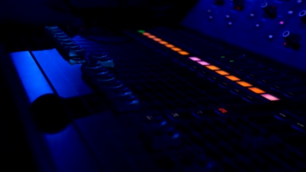 Close up of colorful buttons on the mixing console at night club. Stock footage. Professional concert sound mixer equipment, industrial audio mixing controller panel with volume sliders to control — Stock Video