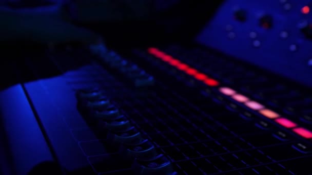 Close up of colorful buttons on the mixing console at night club. Stock footage. Professional concert sound mixer equipment, industrial audio mixing controller panel with volume sliders to control — Stock Video