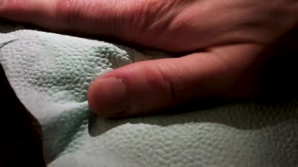 Male hand applying wood care products on a wooden bord with white cloth. Stock footage. Close up of wooden panel oiling process. — Stock Video