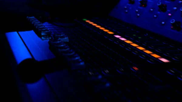 Close up of colorful buttons on the mixing console at night club. Stock footage. Professional concert sound mixer equipment, industrial audio mixing controller panel with volume sliders to control — Stock Photo, Image