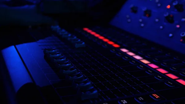 Close up of colorful buttons on the mixing console at night club. Stock footage. Professional concert sound mixer equipment, industrial audio mixing controller panel with volume sliders to control — Stock Photo, Image