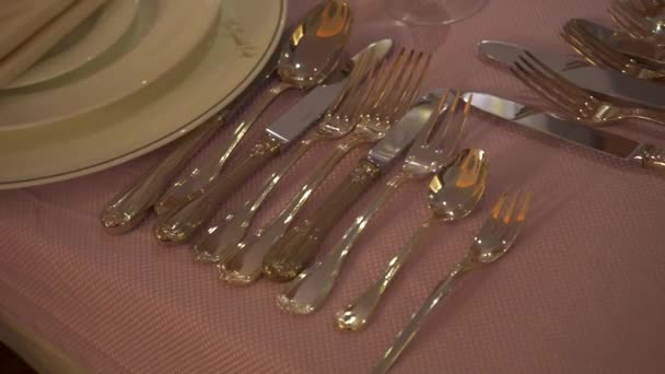 Close-up of gilded elegant set with cutlery. Stock footage. Festive luxurious table setting in Royal style with variety of Cutlery for different meals — Stock Video